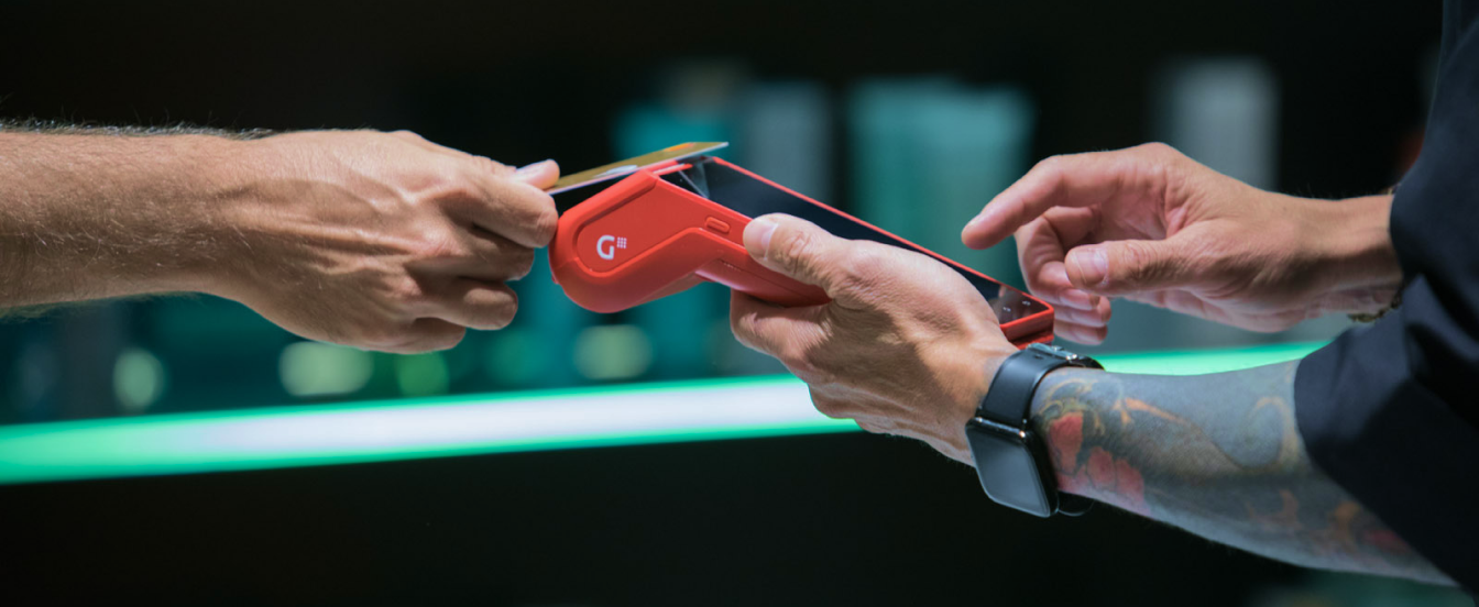 Hand making a card payment at a POS terminal